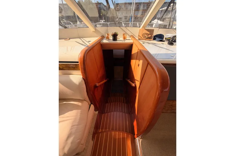 Slide: The Image of Interior view of 2001 Fairline 55 yacht with wooden stairs and seating area. - 92