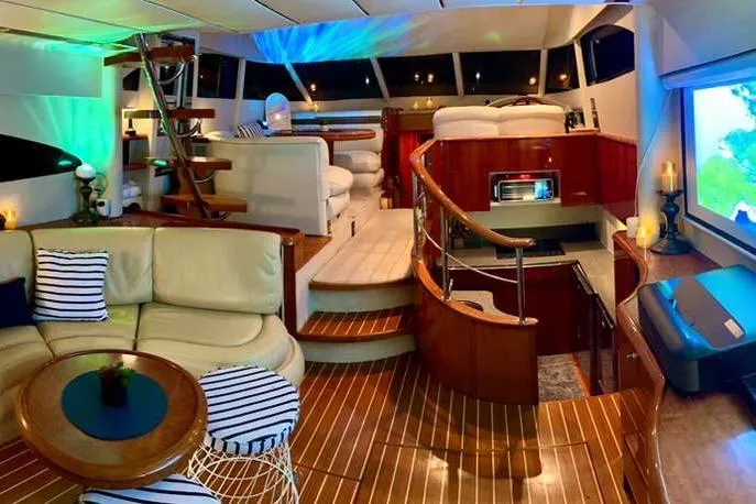 Slide: The Image of Luxurious interior of 2001 Fairline 55 yacht with elegant wood finishes and modern seating. - 144