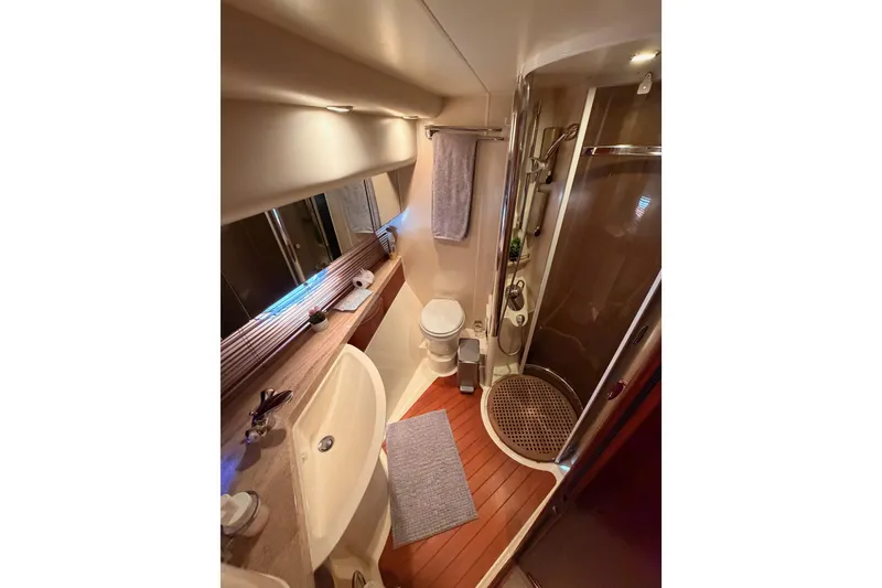 Slide: The Image of Luxurious bathroom in 2001 Fairline 55 yacht with shower, sink, and toilet. - 112