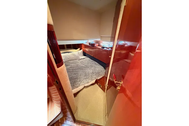 Slide: The Image of Luxurious cabin interior of 2001 Fairline 55 yacht with cozy bedding and wooden finishes. - 107