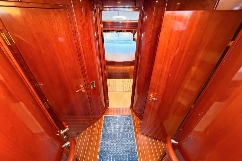 Slide: The Image of Luxurious wooden interior hallway of a 2001 Fairline 55 yacht, leading to a bedroom. - 94