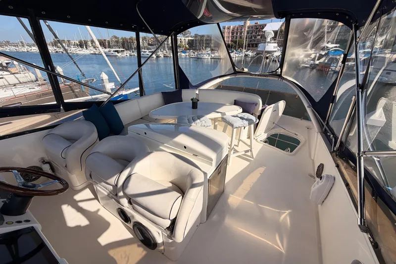 Slide: The Image of Luxurious 2001 Fairline 55 yacht interior with plush seating and marina view. - 60
