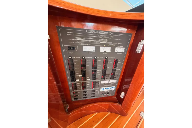 Slide: The Image of Electrical control panel on a 2001 Fairline 55 yacht, featuring switches and gauges. - 43