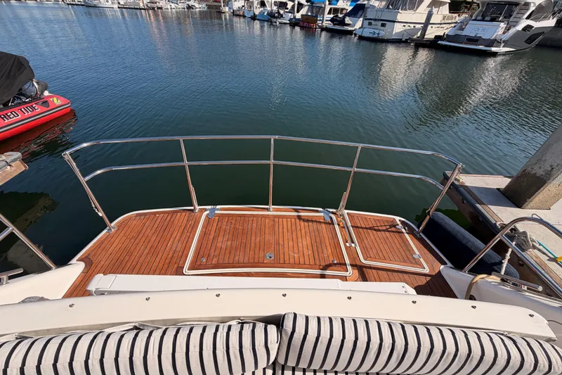 Slide: The Image of 2001 Fairline 55 yacht stern view with wooden deck at marina. - 135