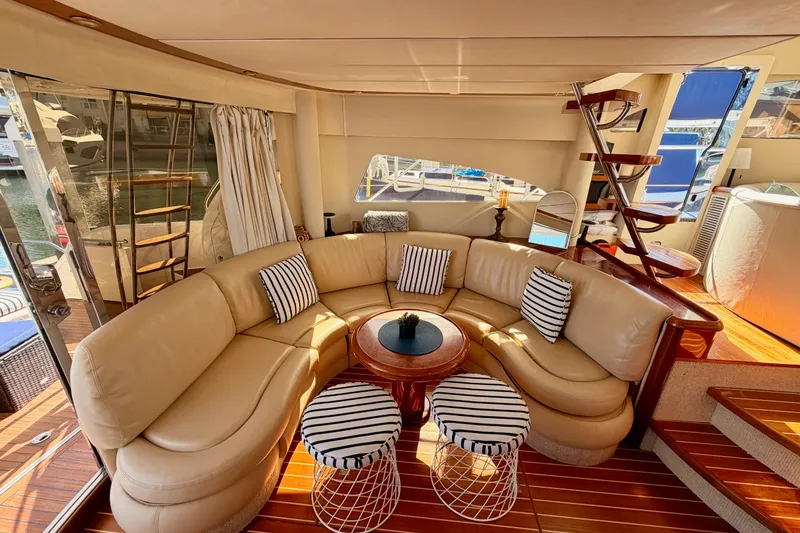 Slide: The Image of Luxurious interior of 2001 Fairline 55 yacht with elegant seating and striped cushions. - 23