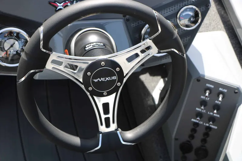 Slide: The Image of The image shows the steering wheel of a Vexus AVX 1980 boat with modern controls. - 37