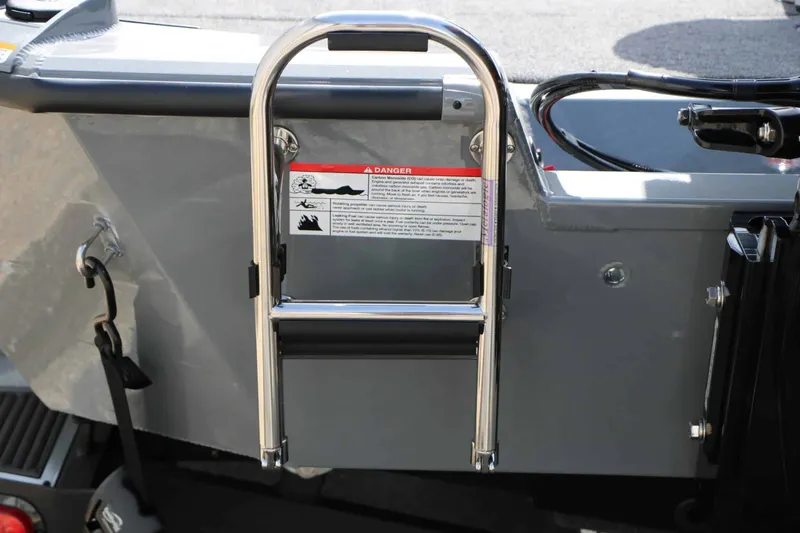Slide: The Image of A swim ladder is attached to the rear of a gray boat. - 13