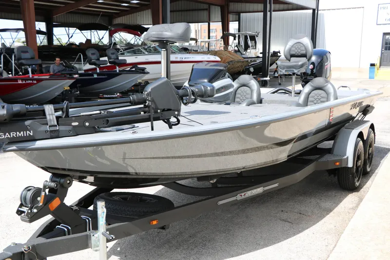 Slide: The Image of A gray 2026 Vexus AVX 1980 boat on a trailer in a covered area. - 24