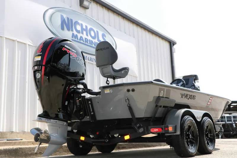 Slide: The Image of A 2026 Vexus AVX 1980 boat on a trailer in front of a building. - 11