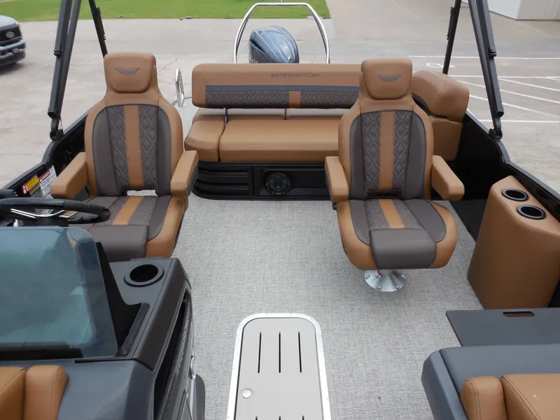 Slide: The Image of Interior of a Bennington 22MSB boat with luxurious brown seating and modern design. - 16