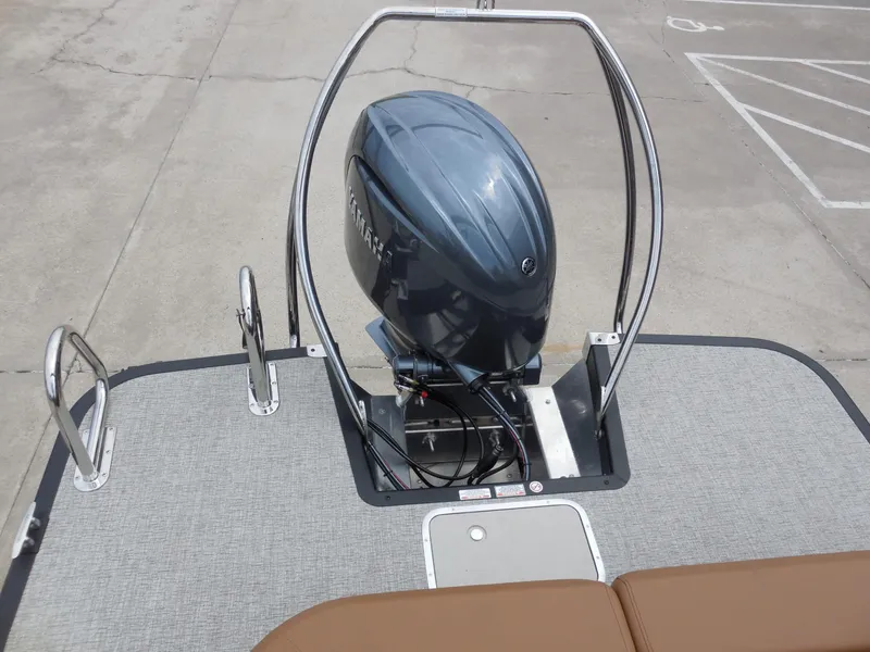 Slide: The Image of The image shows the engine of a Bennington 22MSB boat in a parking area. - 25