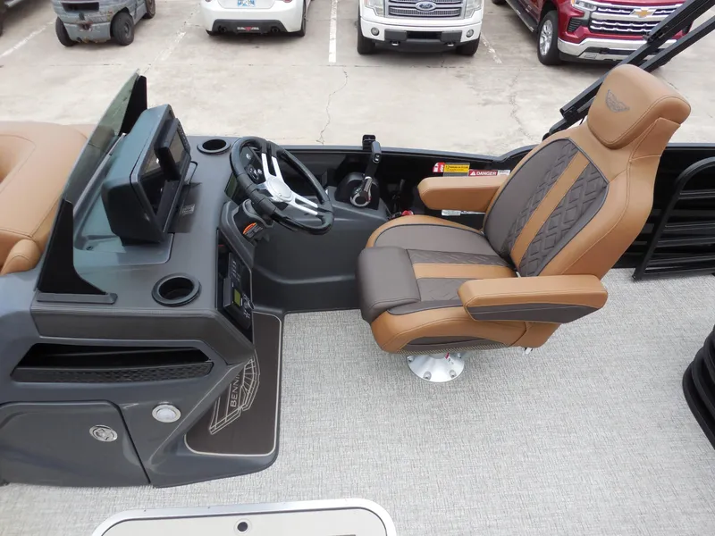 Slide: The Image of The image shows the helm of a Bennington 22MSB boat with a luxurious captain's chair. - 17
