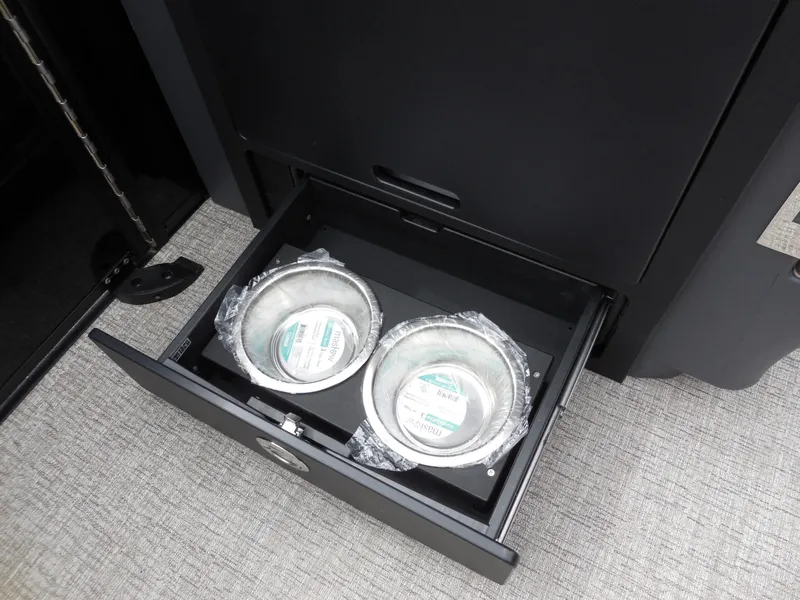 Slide: The Image of A drawer with two stainless steel bowls wrapped in plastic on a boat. - 27