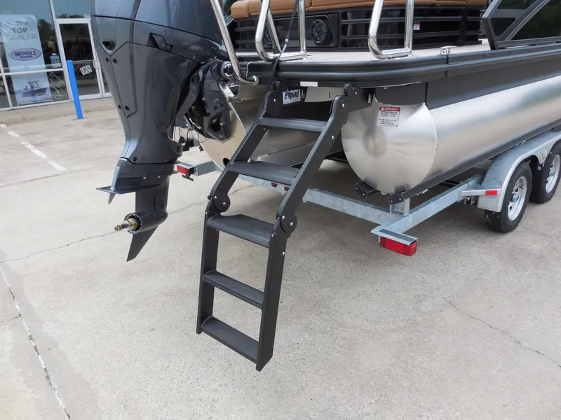 Slide: The Image of 2026 Bennington 22MSB with outboard motor and ladder on a trailer. - 13