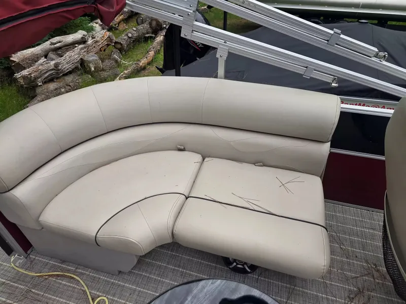 Slide: The Image of A cream-colored seating sofa on a boat with a table in the foreground. - 10