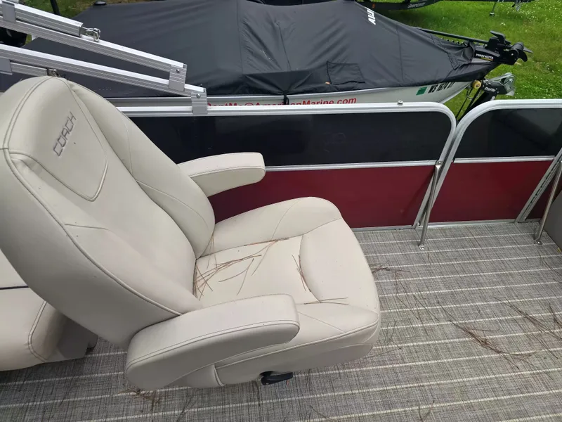 Slide: The Image of A beige seat on a boat with a red railing and gray flooring. - 7