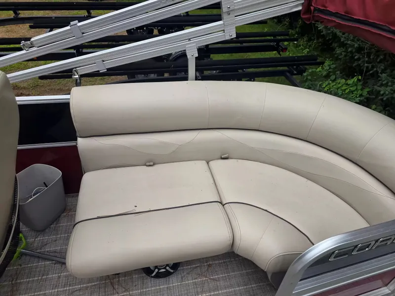 Slide: The Image of A cream-colored leather sofa on a boat with metal railing in the background. - 9