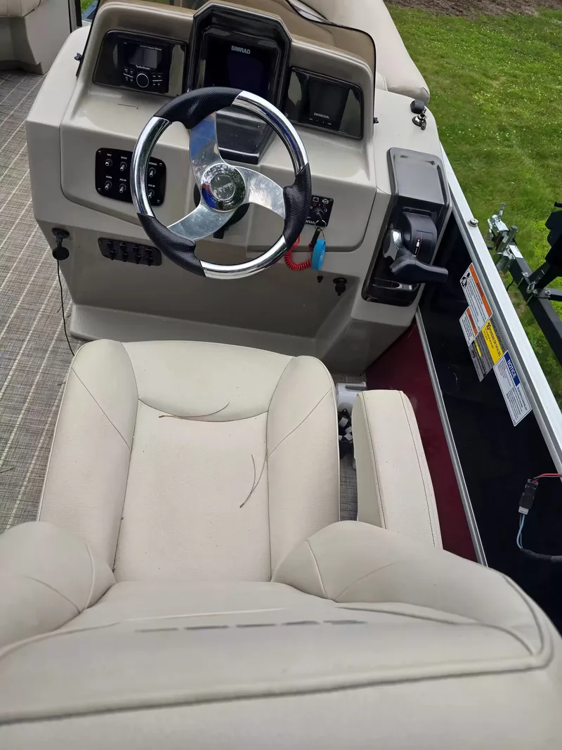 Slide: The Image of The image shows a boat cockpit with a steering wheel and beige seating. - 6