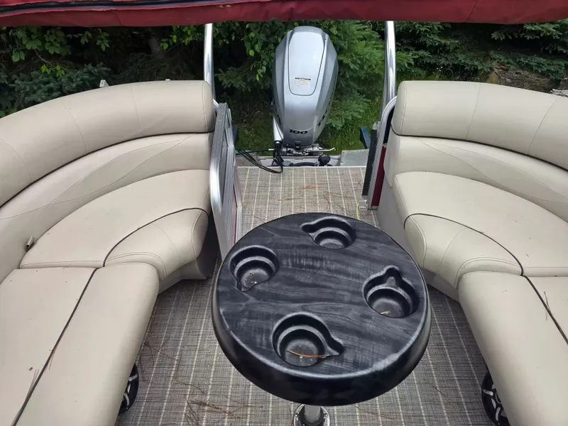 Slide: The Image of The image shows the interior of a pontoon boat with beige seating and a table. - 8