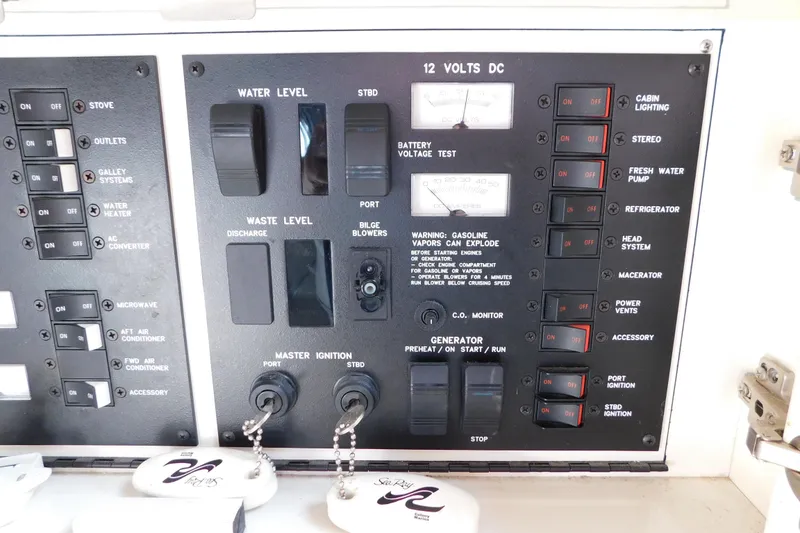 Slide: The Image of Control panel of a 1997 Sea Ray 330 Express Cruiser with various switches and indicators. - 54