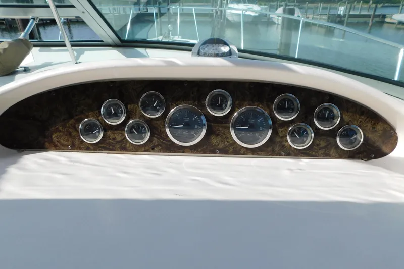 Slide: The Image of Dashboard of a 1997 Sea Ray 330 Express Cruiser with multiple gauges and controls. - 29