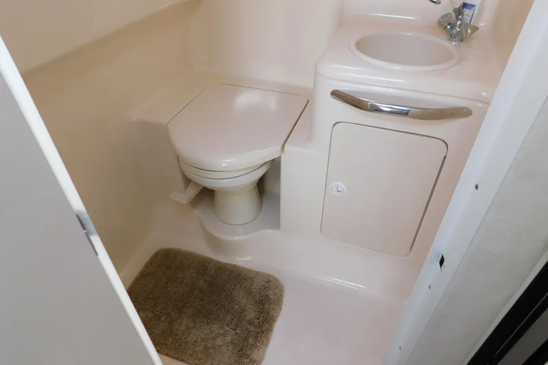 Slide: The Image of Bathroom interior of 1997 Sea Ray 330 Express Cruiser with toilet and sink. - 78