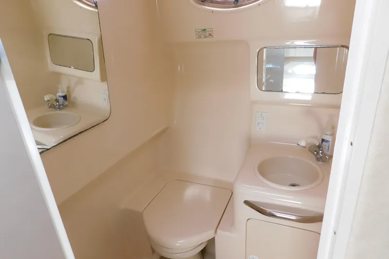 Slide: The Image of Bathroom interior of 1997 Sea Ray 330 Express Cruiser with sink and toilet. - 80