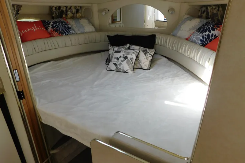 Slide: The Image of 1997 Sea Ray 330 Express Cruiser cabin with cozy bed and decorative pillows. - 63