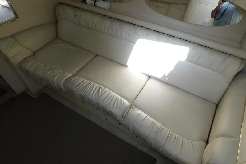 Slide: The Image of Luxurious white leather seating inside a 1997 Sea Ray 330 Express Cruiser yacht. - 47