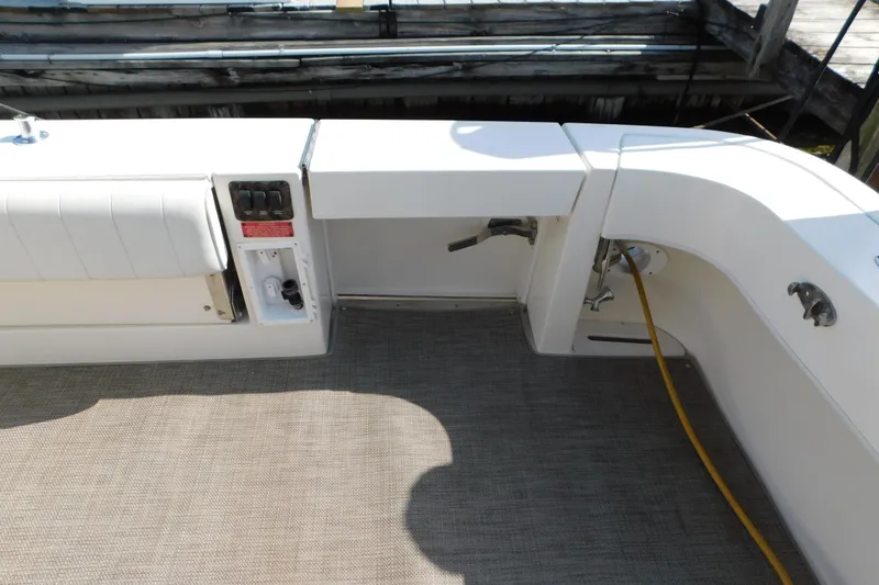 Slide: The Image of 1997 Sea Ray 330 Express Cruiser deck with seating and utility connections. - 13