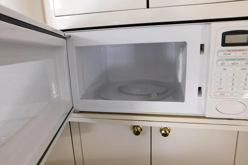 Slide: The Image of Open microwave oven in a 1997 Sea Ray 330 Express Cruiser kitchen. - 69