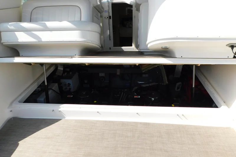 Slide: The Image of 1997 Sea Ray 330 Express Cruiser engine compartment with open hatch, showcasing interior details. - 84