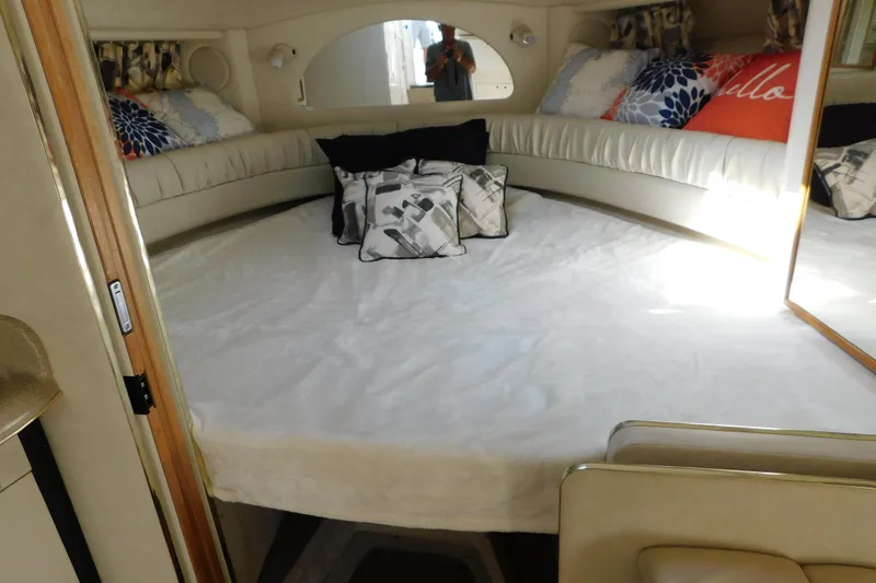 Slide: The Image of Interior cabin of 1997 Sea Ray 330 Express Cruiser with bed and decorative pillows. - 58