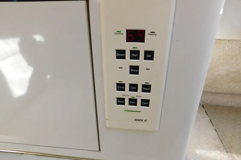 Slide: The Image of Thermostat control panel on a 1997 Sea Ray 330 Express Cruiser, displaying temperature settings. - 50