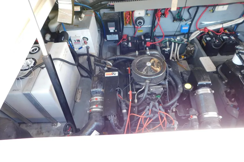 Slide: The Image of Engine compartment of a 1997 Sea Ray 330 Express Cruiser with visible wiring and components. - 85