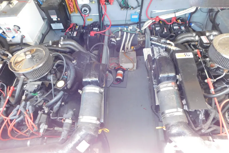 Slide: The Image of Engine compartment of a 1997 Sea Ray 330 Express Cruiser with dual engines and wiring. - 86
