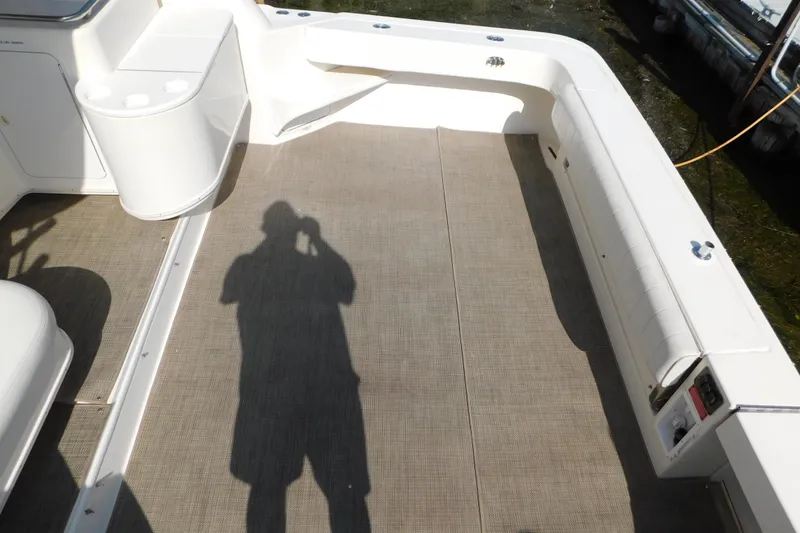 Slide: The Image of 1997 Sea Ray 330 Express Cruiser deck with seating and shadow. - 12