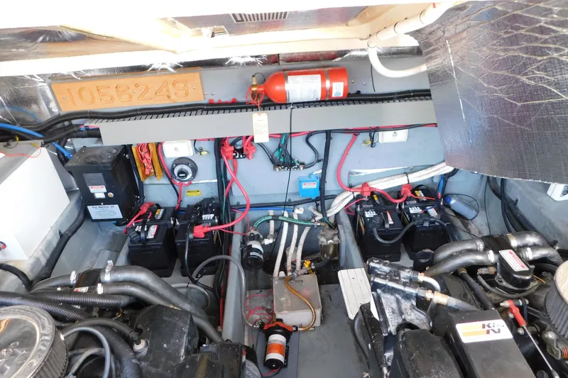 Slide: The Image of Engine compartment of a 1997 Sea Ray 330 Express Cruiser with visible wiring and components. - 90