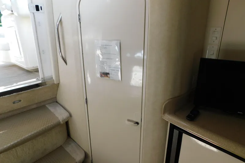 Slide: The Image of Interior view of 1997 Sea Ray 330 Express Cruiser, featuring cabin door and steps. - 77
