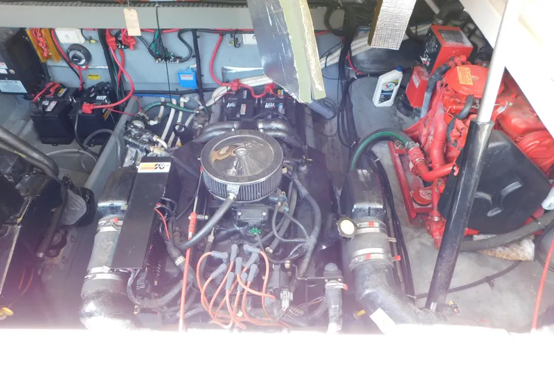 Slide: The Image of Engine compartment of a 1997 Sea Ray 330 Express Cruiser, showcasing mechanical components and wiring. - 87