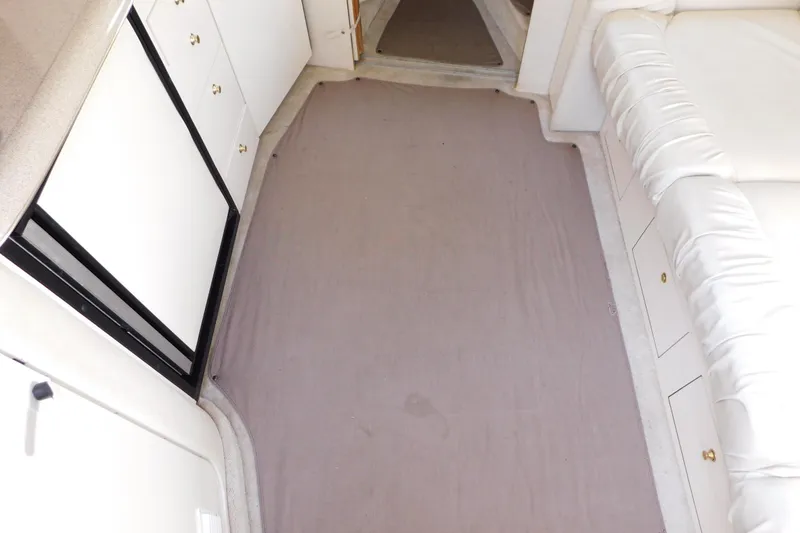 Slide: The Image of Interior of 1997 Sea Ray 330 Express Cruiser with white cabinetry and seating. - 48