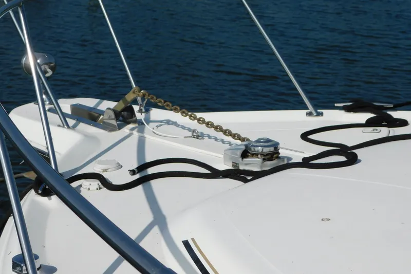 Slide: The Image of Bow of 1997 Sea Ray 330 Express Cruiser with anchor chain and ropes on water. - 9