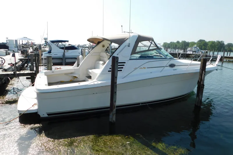 The Image of 1997 Sea Ray 330 Express Cruiser docked at a marina. - 0