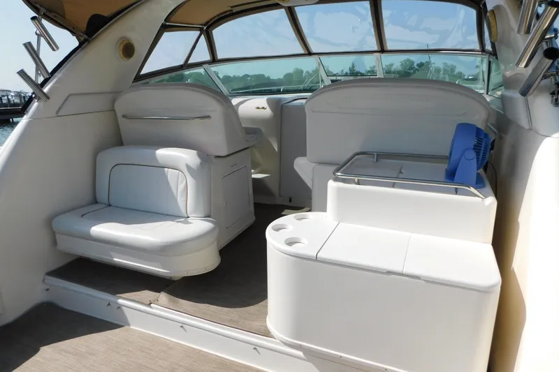 Slide: The Image of 1997 Sea Ray 330 Express Cruiser interior with white seating and helm station. - 18
