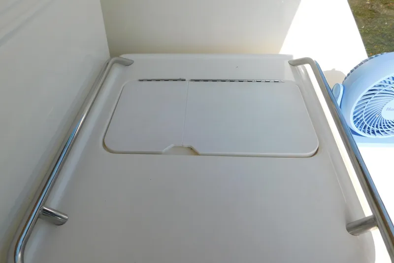 Slide: The Image of 1997 Sea Ray 330 Express Cruiser deck with stainless steel rails and a small fan. - 22