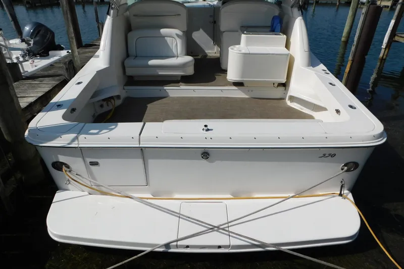 Slide: The Image of 1997 Sea Ray 330 Express Cruiser docked, showcasing spacious rear deck and seating area. - 4