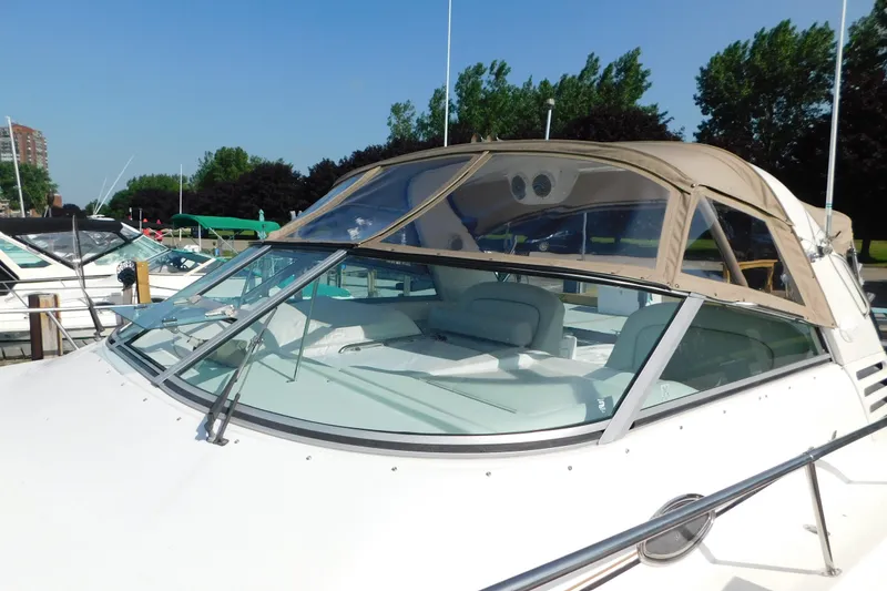 Slide: The Image of 1997 Sea Ray 330 Express Cruiser docked, featuring a sleek design and spacious cockpit. - 10