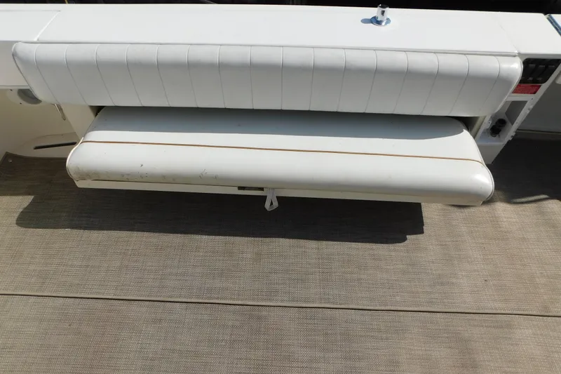 Slide: The Image of 1997 Sea Ray 330 Express Cruiser's white cushioned seating on deck. - 15