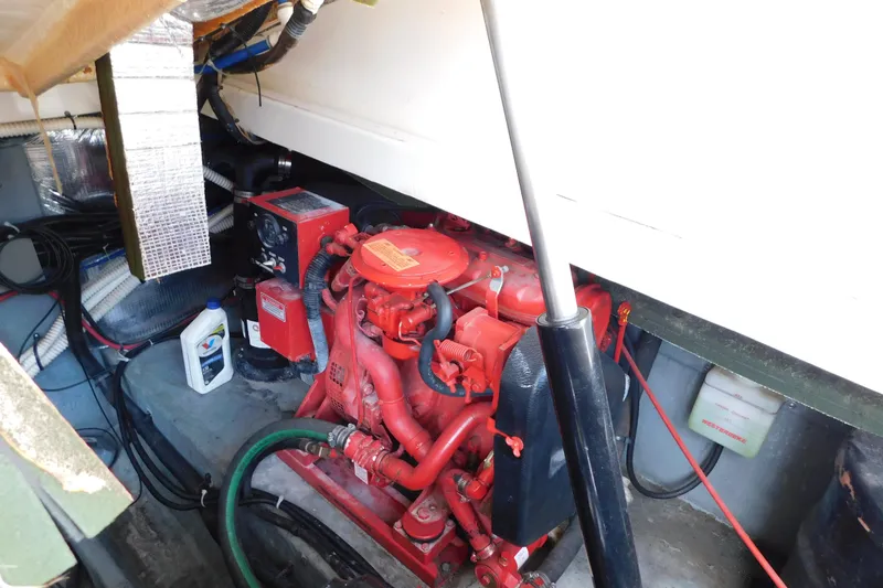 Slide: The Image of Engine compartment of a 1997 Sea Ray 330 Express Cruiser with visible red engine components. - 91