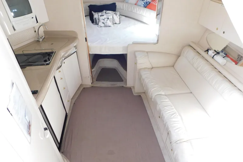Slide: The Image of Interior of 1997 Sea Ray 330 Express Cruiser with kitchenette, sofa, and sleeping area. - 82